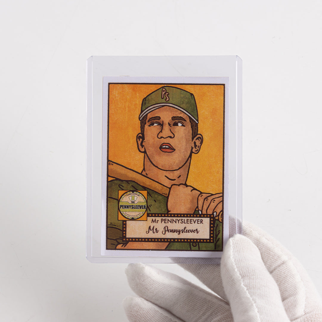 White gloved hand holding up a baseball card in a 75 point toploader.